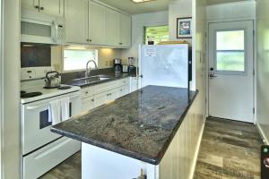 a kitchen with white appliances and a granite counter top at Condos in Kapa'a Sands in Kapaa
