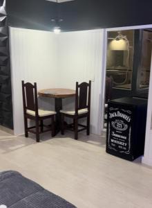 a dining room with a table and two chairs at Tennessee Motel ltda in Bragança Paulista