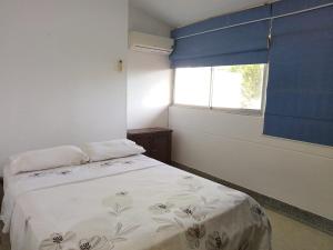 1 dormitorio con cama y ventana en Apartamento duplex Buganaviles, en Neiva