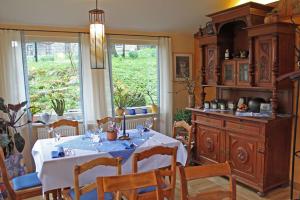 a dining room with a table and a large window at Landgasthaus Schwarzbachtal in Lohsdorf