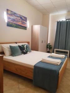 a bedroom with a large bed and a cabinet at Casa da Vera in Faro