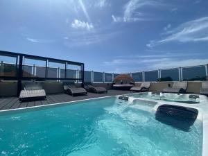 a swimming pool on the roof of a building at Myah's Hotel in Brighton Village