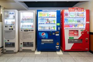four vending machines are lined up next to each other at サザンシティホテル in Nankoku