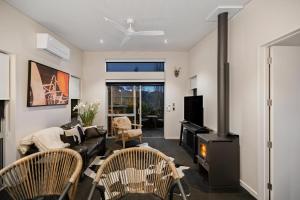 a living room with a couch and a fireplace at Queenstown Hot Tub Apartment in Frankton Wharf