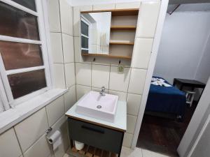 a bathroom with a sink and a mirror at Hotel Real Koerich 24h in Rio do Sul