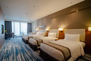 Voodi või voodid majutusasutuse Horizon Hotel toas