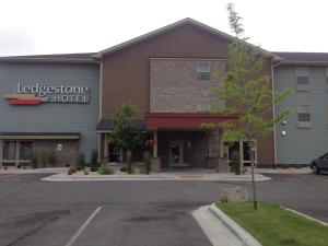 a front view of a hotel with a parking lot at Ledgestone Hotel Billings in Billings