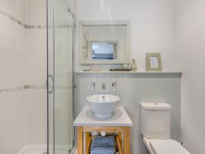 a bathroom with a sink and a toilet and a shower at High Bank in Pontesbury