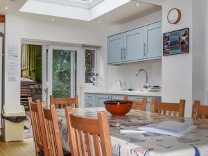 a kitchen with a table with a bowl on it at Windward House in Salcombe