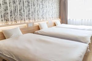 Postel nebo postele na pokoji v ubytování Kansai International Airport Hotel 11