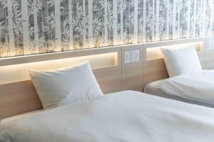 Postel nebo postele na pokoji v ubytování Kansai International Airport Hotel 11