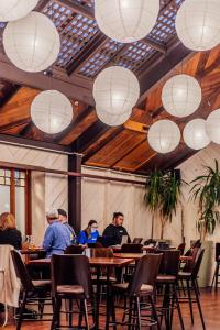 um grupo de pessoas sentadas numa mesa com luzes brancas em The Cambridge Hotel em Wellington