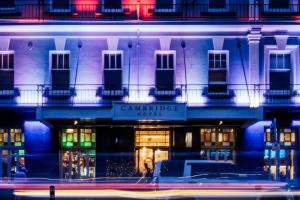 a building with a car parked in front of it at The Cambridge Hotel & Backpackers in Wellington