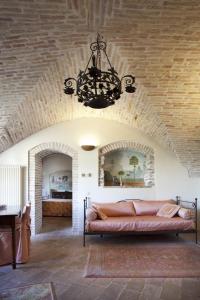 sala de estar con sofá y lámpara de araña en Residenza D'epoca San Crispino en Assisi