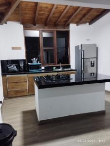 a kitchen with a stove and a refrigerator at El Paso Gh #3 in Guarne