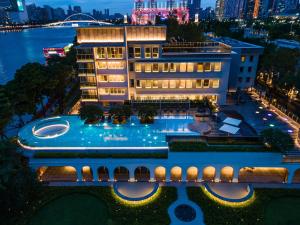 an aerial view of a hotel with a pool at night at Hotel Indigo Guangzhou Haixinsha, an IHG Hotel - Complimentary Social hour at Flow in Guangzhou