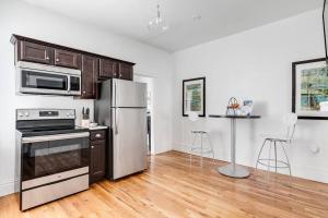 a kitchen with a stainless steel refrigerator and a stove at Chic Urban Couples Retreat: Perfect Getaway 'n RVA in Richmond