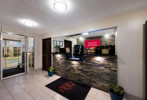 a lobby with a stone wall and a cash register at Red Roof Inn Dahlgren - Naval Base in Dahlgren