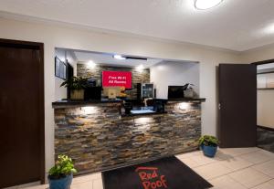 a bar in a lobby with a stone wall at Red Roof Inn Dahlgren - Naval Base in Dahlgren