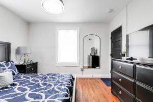 a bedroom with a bed and a dresser and a mirror at Charming, Happy 1-Bed Oasis: RVA Retreat Awaits! in Richmond
