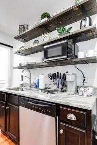 a kitchen with a sink and a microwave at Charming, Happy 1-Bed Oasis: RVA Retreat Awaits! in Richmond