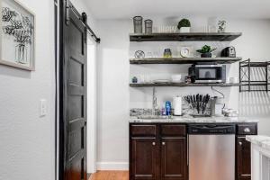 a kitchen with a sink and a dishwasher at Charming, Happy 1-Bed Oasis: RVA Retreat Awaits! in Richmond