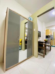 a sliding glass door in a room with a desk at Wind Residences Apt. 1506 Tagaytay in Tagaytay