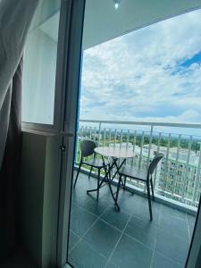 a table and chairs on a balcony with a view at Wind Residences Apt. 1506 Tagaytay in Tagaytay