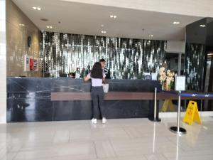 a woman standing in front of a counter in a building at Wind Residences Apt. 1506 Tagaytay in Tagaytay +46 photos