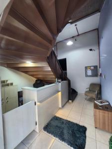 a small room with a couch and a table at Hotel Real Koerich 24h in Rio do Sul