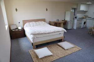 a bedroom with a bed with two pillows on the floor at SamDalChae in Seogwipo