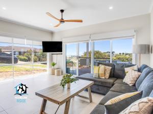 a living room with a couch and a table at Brand New 3 Bed 2 Bath with Sea Views in Encounter Bay