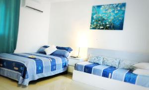 a bedroom with two beds and a couch at Sol Caribe Beach Pool in Punta Cana