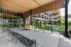 a group of benches sitting outside of a building at The Siamese Hotel by PCL in North Pattaya