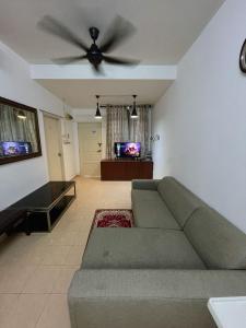 Una sala de estar con un sofá y un ventilador de techo. en Nurjah Homestay, en Kuala Terengganu