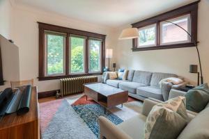a living room with a couch and a table at Cozy 3 bedroom house with office in Kitchener