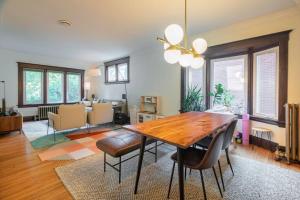 a living room with a wooden table and chairs at Cozy 3 bedroom house with office in Kitchener