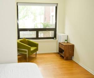 a living room with a green chair and a window at Stunning 3BR Chicago Apt close to Shopping Center in Chicago