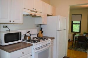 a kitchen with a stove and a white refrigerator at Stunning 3BR Chicago Apt close to Shopping Center in Chicago
