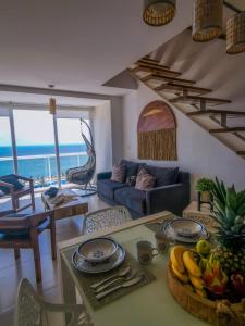 a living room with a table with fruit on it at Pent House amazing View beachfront CANCUN in Cancún