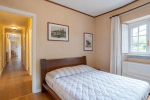 a bedroom with a bed and a window at Villa Colle in Ossuccio