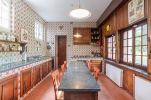 a large kitchen with a long table and chairs at Villa Colle in Ossuccio