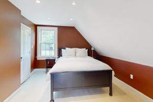 a bedroom with a large bed in a attic at The Sugar House in Bridgewater