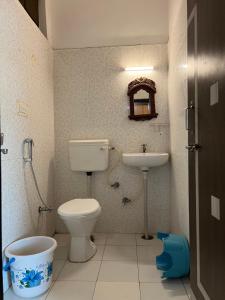 a bathroom with a toilet and a sink at Hotstel Udaipur in Udaipur