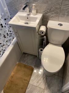 a bathroom with a white toilet and a sink at Windsor Airport Accommodation in Windsor