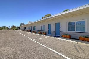 um parque de estacionamento vazio em frente a um edifício em White Caps Motel em Ventura