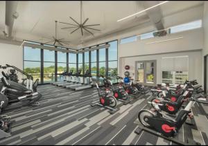 a gym with a lot of bikes and treadmills at Cozy Retreat-Free Reserved Parking-Pool in Addison