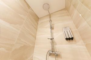 a shower in a bathroom with a shower head at Hotel Star Premier Yeoksam in Seoul