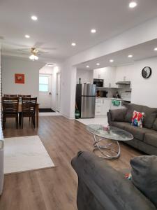 a living room with a couch and a table at Pigeon Lake Cottage in Kawartha Lakes