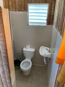 a small bathroom with a toilet and a sink at SamHotels in Salado